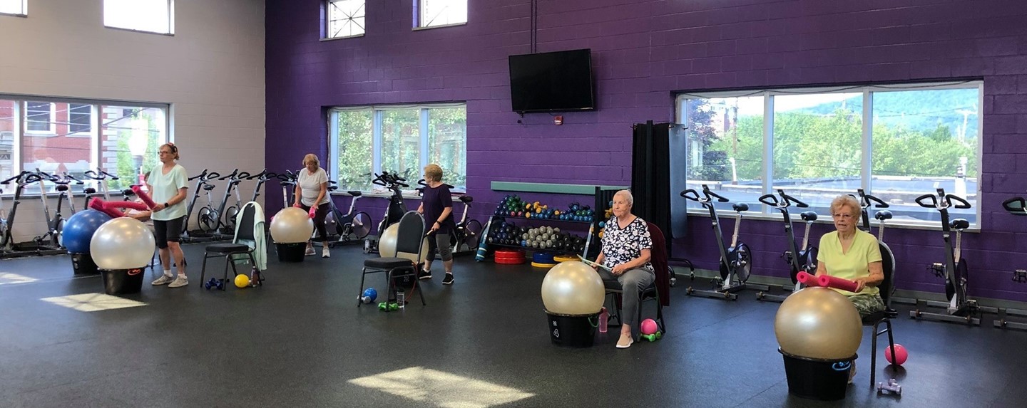 seniors drumming on exercise balls