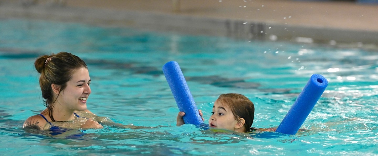 young girl and female instructor doing a swim lesson in the pool