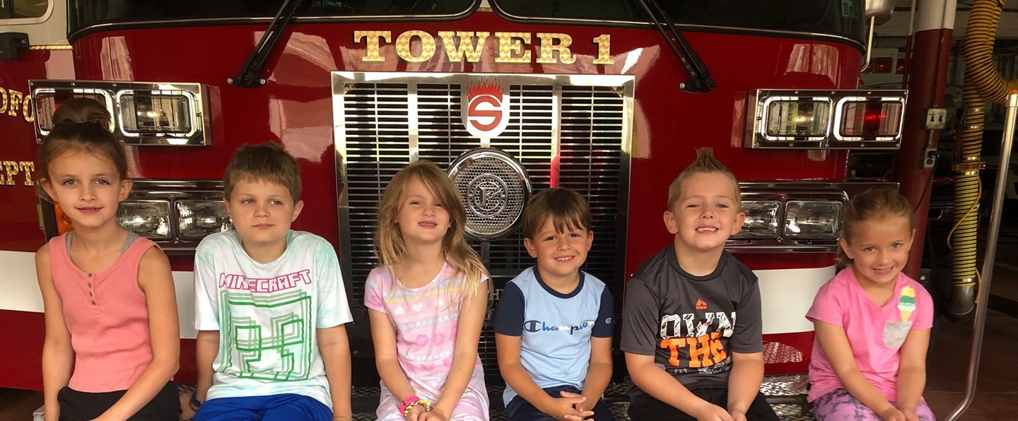 children sitting on a fire truck