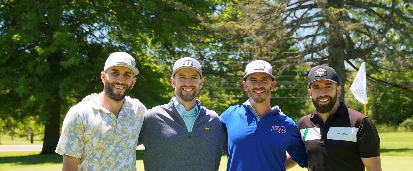 four men at golf tournament