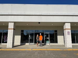brianna simms and Kinley Construction member in front of store front