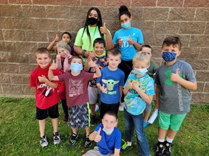 children wearing masks with care givers